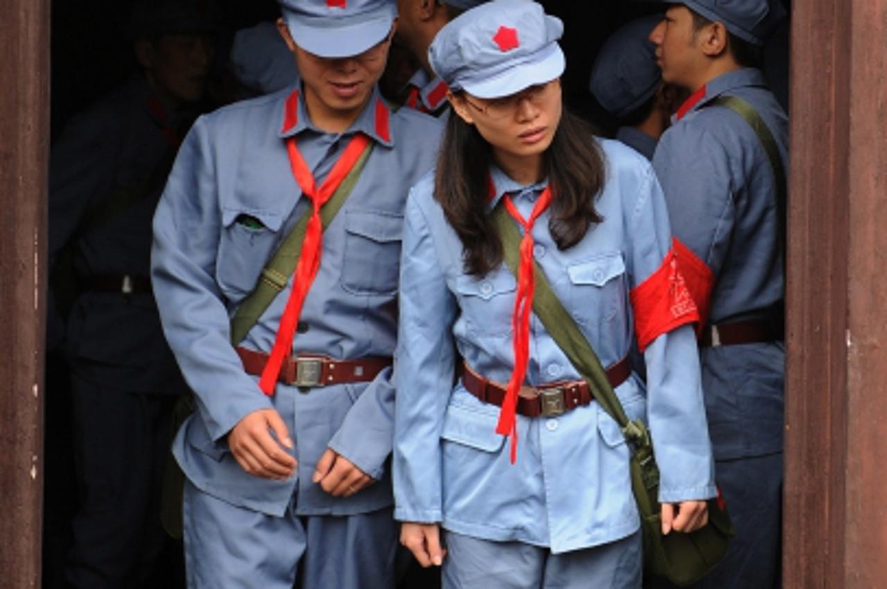 'Photo taken on September 21, 2012 shows visitors dressed in red army uniforms visiting places former Chinese leader Mao Zedong used to stay, during an educational tour in Jinggangshan in central Chin