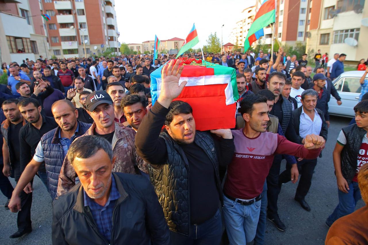 People carry the coffin of a member of Azerbaijani Armed Forces who was allegedly killed during the fighting over the breakaway region of Nagorno-Karabakh, in Tartar district
