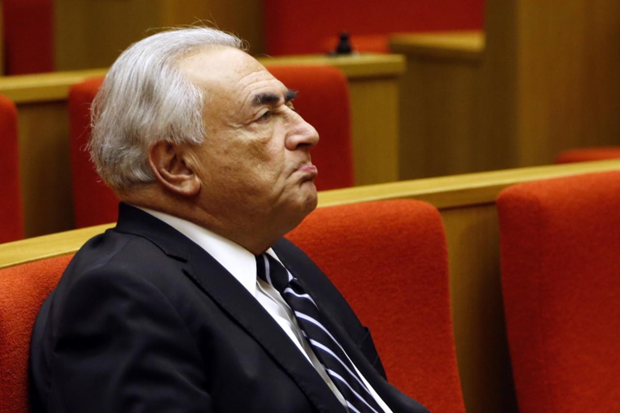 'Former International Monetary Fund (IMF) chief Dominique Strauss-Kahn reacts as he attends a French Senate commission inquiry on the role of banks in tax evasion in Paris in this June 26, 2013 file p