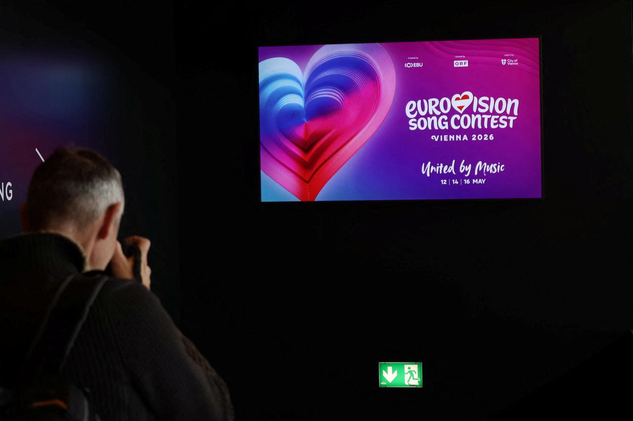 A photographer takes a picture of a TV screen in Wiener Stadthalle, the venue of next year's Eurovision in Vienna