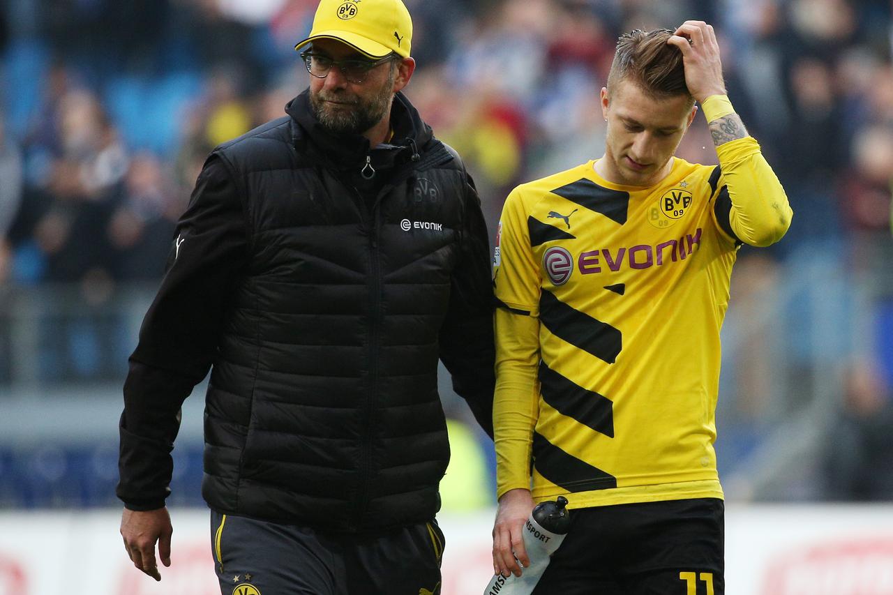 Dortmund's head coach Juergen Klopp and Dortmund's Marco Reus (R) walk across the pitch after the German Bundesliga soccer match between Hamburger SV and Borussia Dortmund in Hamburg, Germany, 07 March 2015. Photo: Christian Charisius/dpa/DPA/PIXSELL