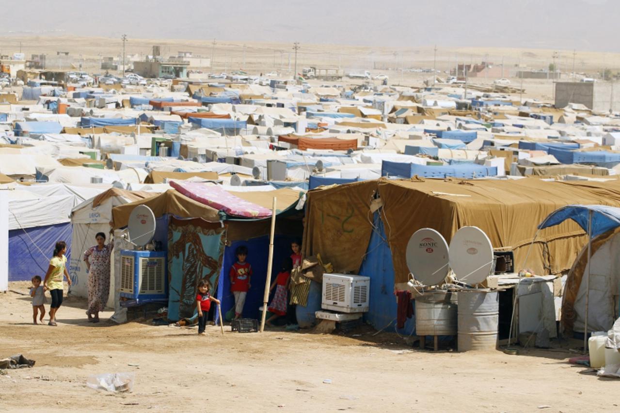 'Syrian refugees, who fled the violence back home, are seen at the Domiz refugee camp in the northern Iraqi province of Dohuk, August 21, 2013. The government of Iraqi Kurdistan has set an entry quota