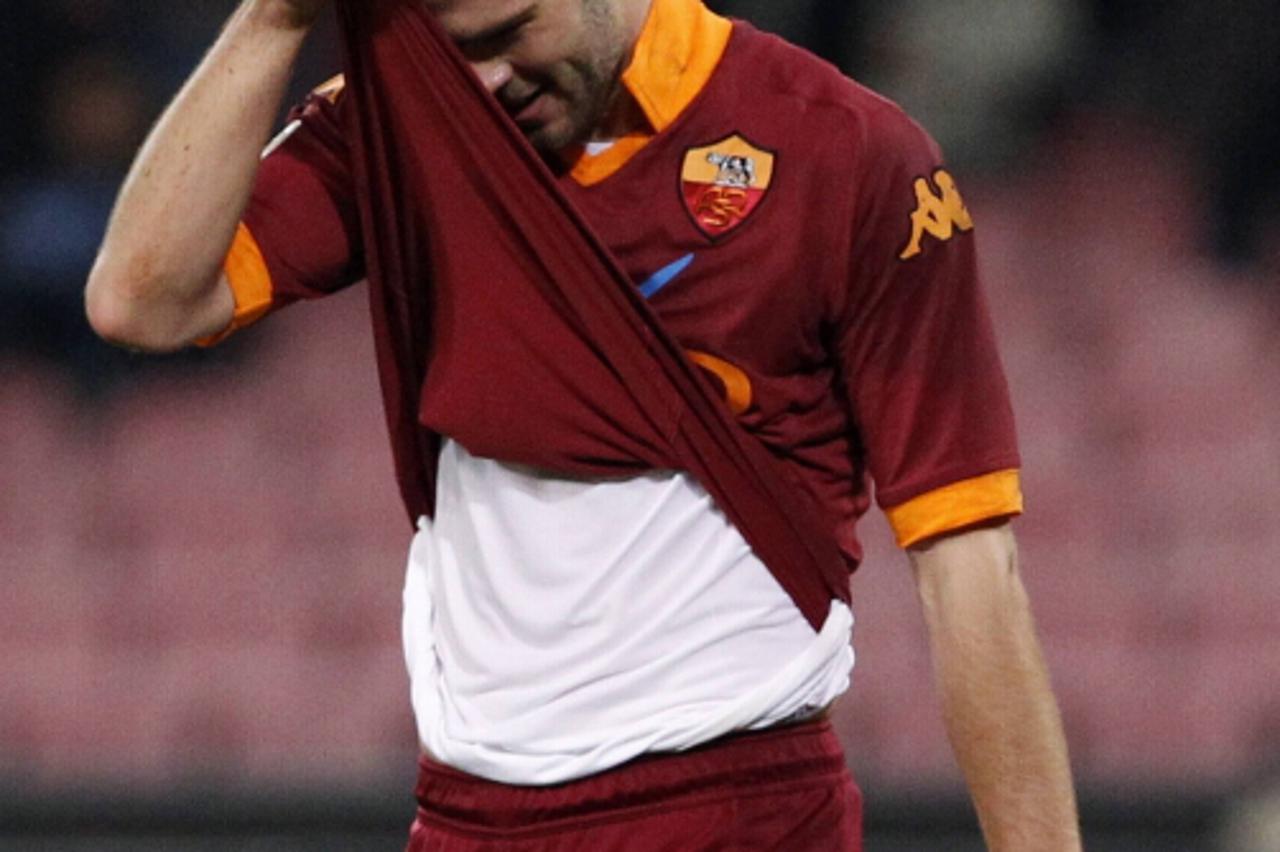 'AS Roma's Miralem Pjanic reacts after receiving a red card during his team's Italian Serie A soccer match against Napoli at San Paolo stadium in Naples January 6, 2013. REUTERS/Ciro De Luca  (ITALY