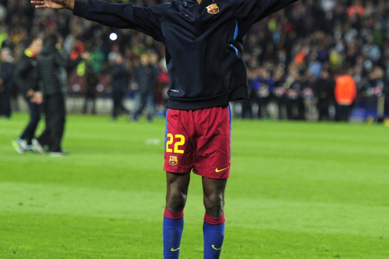 \'Barcelona\'s French defender Eric Abidal  celebrates after winning the Champions League semi-final second leg football match between Barcelona and Real Madrid at the Camp Nou stadium in Barcelona on