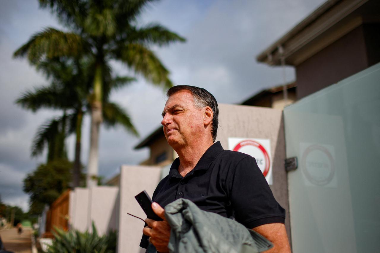 Former Brazilian President Jair Bolsonaro stands in front of his house before testifying to the Federal Police in Brasilia