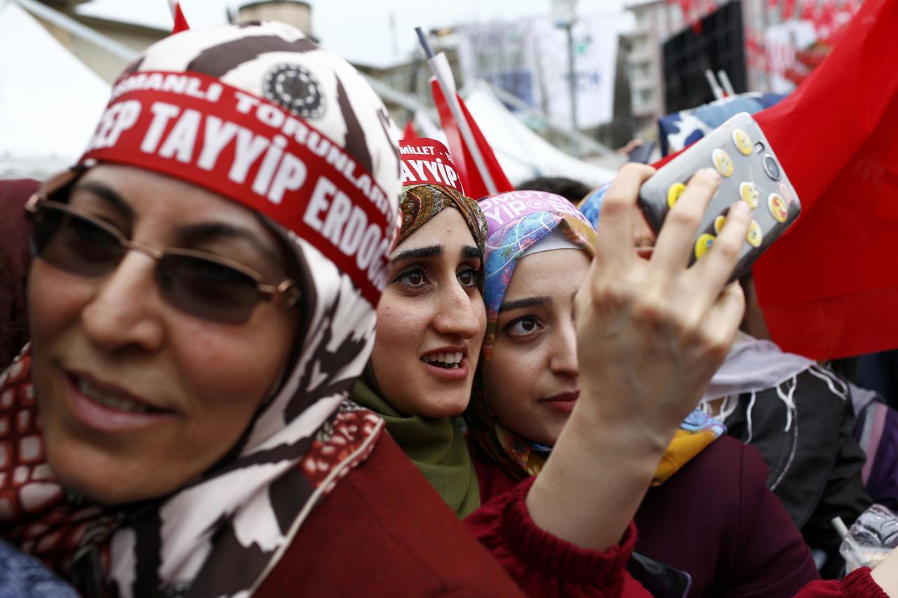 Supporters of Turkish President Tayyip Erdogan take a selfie as they wait for the start of a rally for the upcoming referendum in the Kurdish-dominated southeastern city of Diyarbakir, Turkey, April 1, 2017.  REUTERS/Murad Sezer TPX IMAGES OF THE DAY