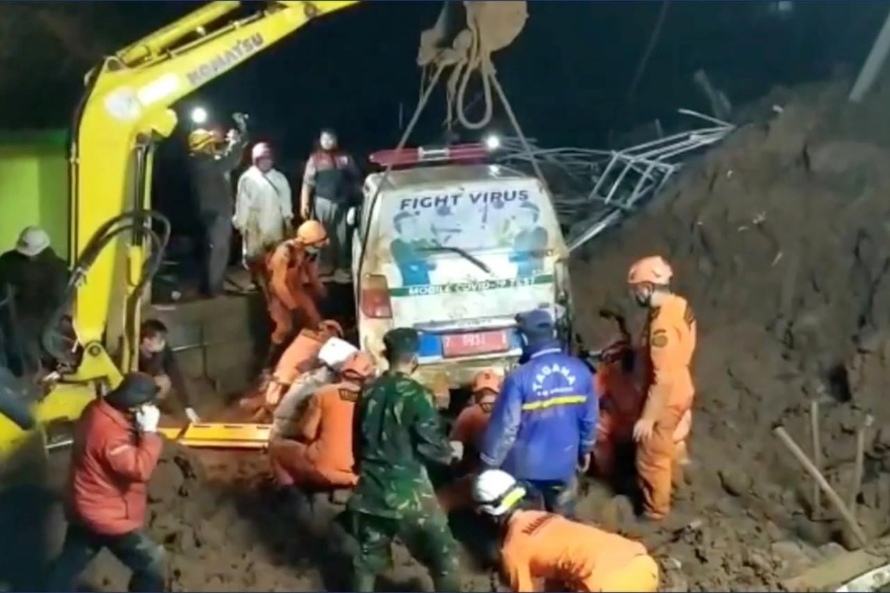An ambulance is being lifted after it was buried in a landslide in Sumedang, West Java, Indonesia