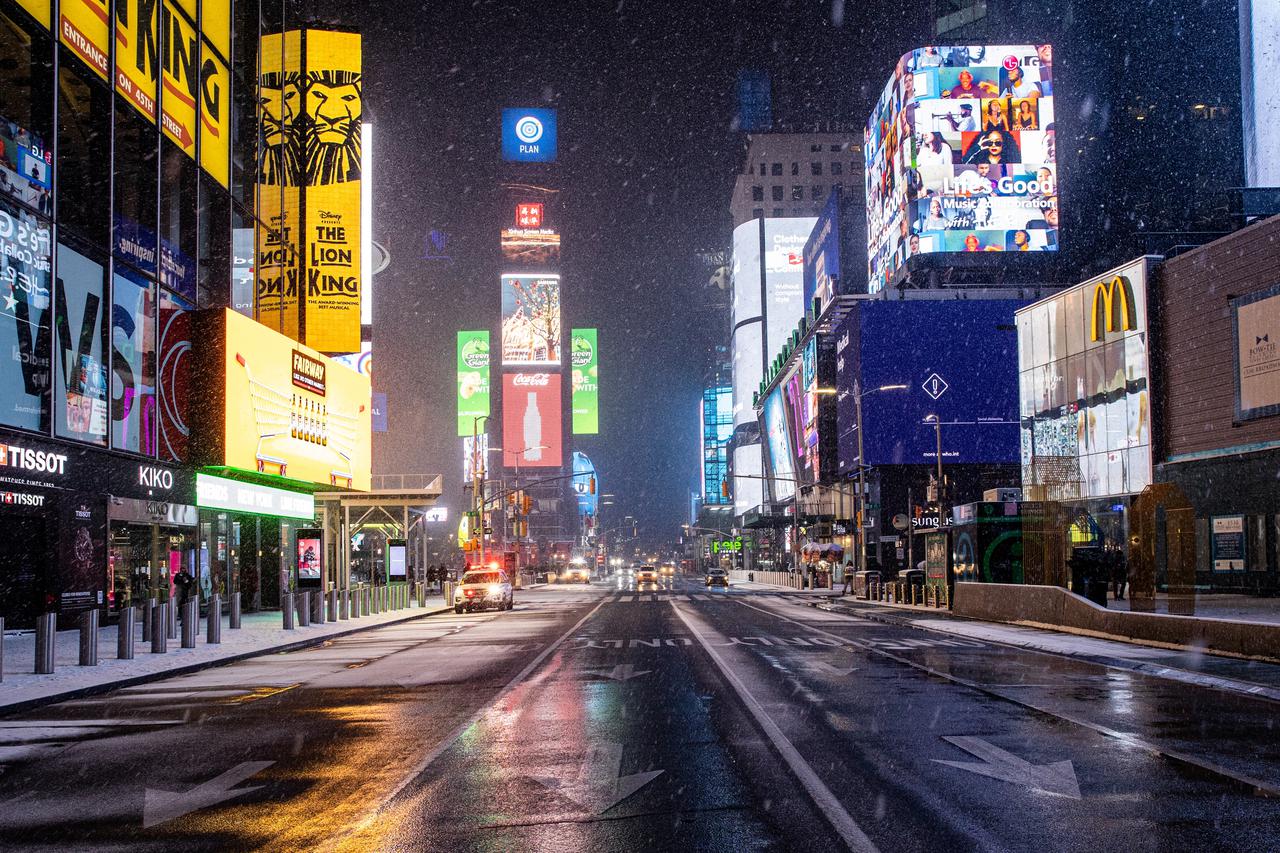 Snow begins to fall in Times Square during a snow storm, during the coronavirus disease (COVID-19) pandemic in the Manhattan borough of New York City