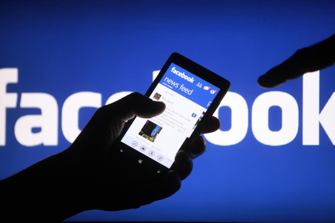 'A smartphone user shows the Facebook application on his phone in the central Bosnian town of Zenica, in this photo illustration, May 2, 2013. Facebook Inc said July 24, 2013 that revenue in the secon