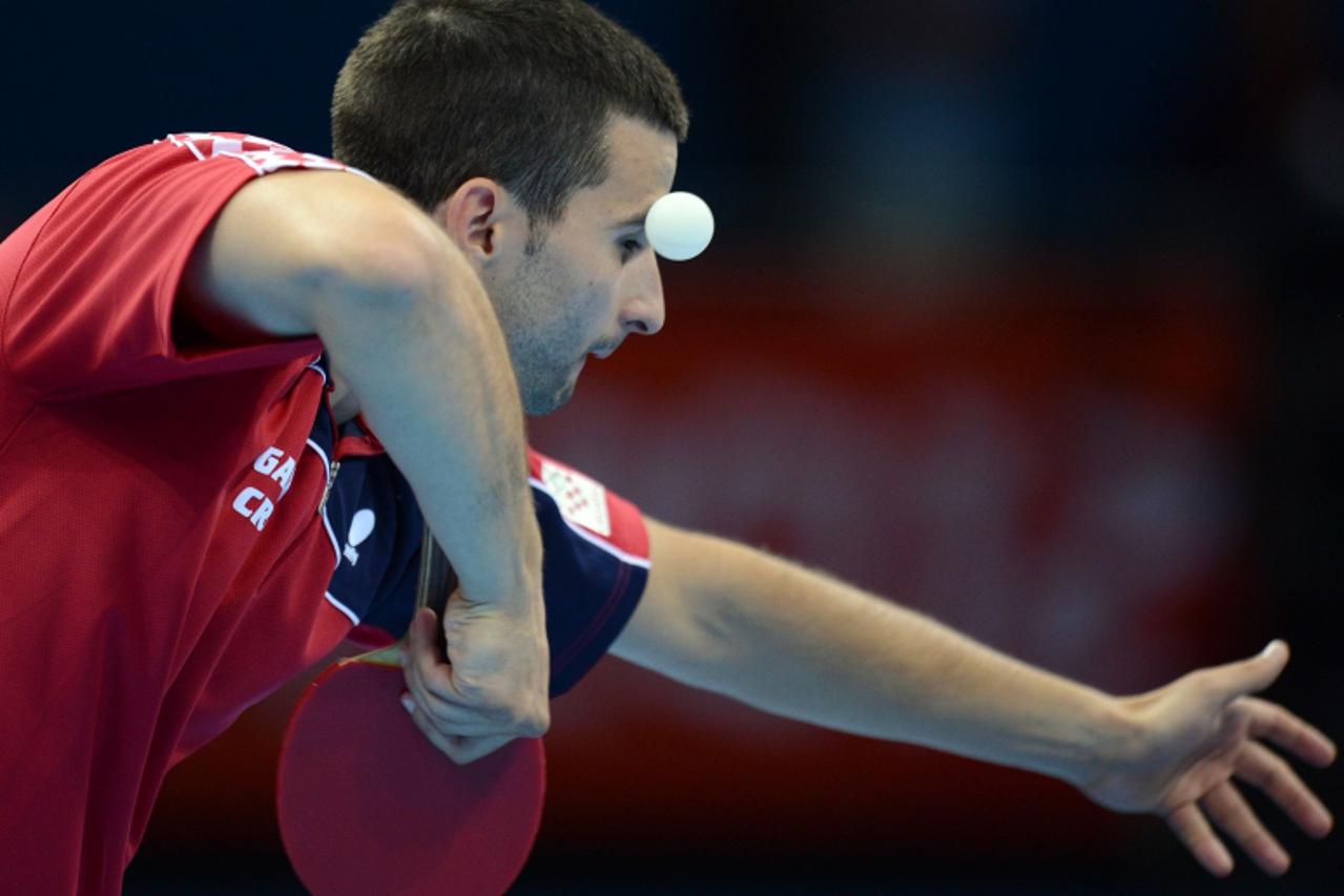'Andrej Gacina of Croatia serves to Jorgen Persson of Sweden during a table tennis men's single preliminary round match of the London 2012 Olympic Games at the Excel centre in London on July 29, 2012