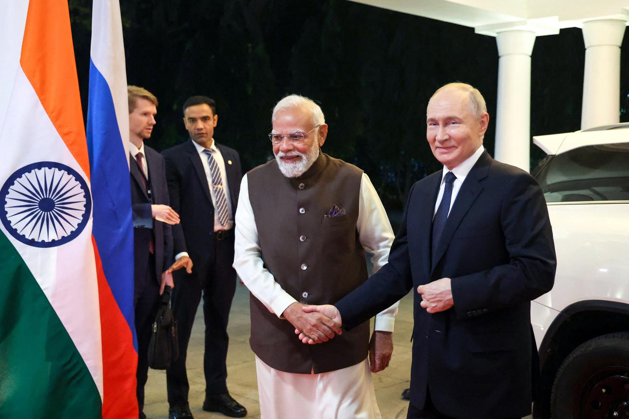 Russian President Vladimir Putin and Indian Prime Minister Narendra Modi arrive for an informal dinner in New Delhi
