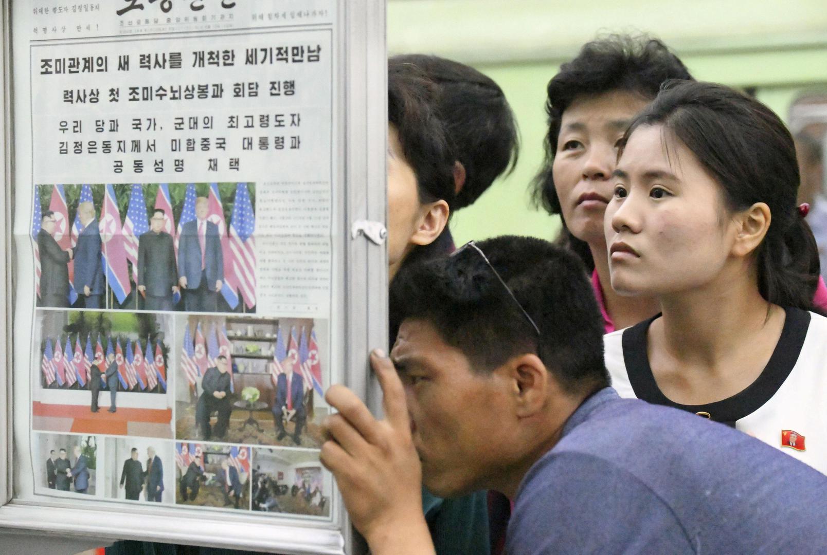 Sjevernokorejci na elektroničkim stupovima čitaju vijesti s povijesnog summita u Singapuru