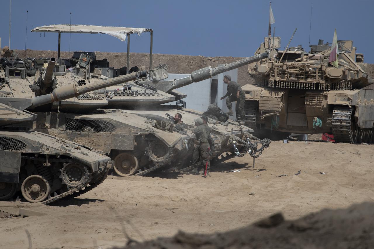 IDF soldiers on tanks in staging area near Gaza Strip border inside southern Israel