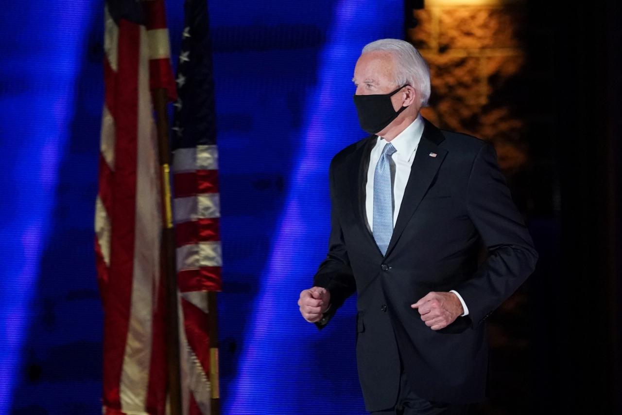 Democratic 2020 U.S. presidential nominee Joe Biden runs on the stage at his election rally in Wilmington