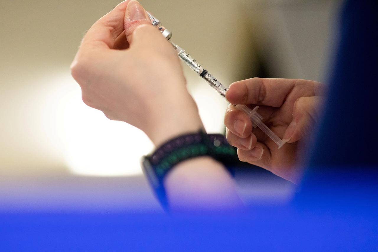 FILE PHOTO: People receive their second COVID-19 boosters in Waterford, Michigan