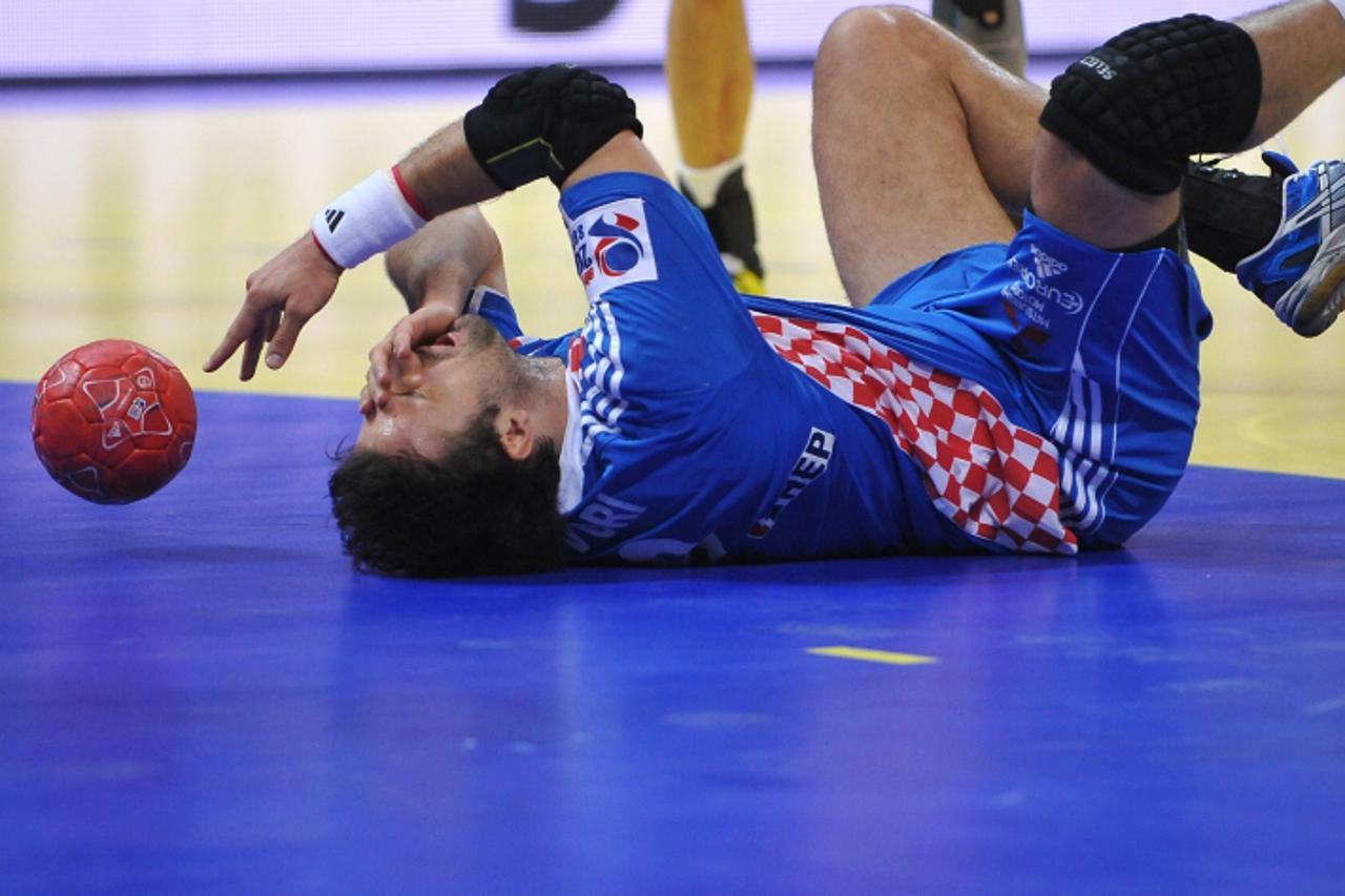 'Croatia\'s Igor Vori reacts in pain during the men\'s EHF Euro 2012 Handball Championship bronze medal match Croatia vs Spain on January 29, 2012 at the Beogradska Arena in Belgrade.   AFP PHOTO / AN