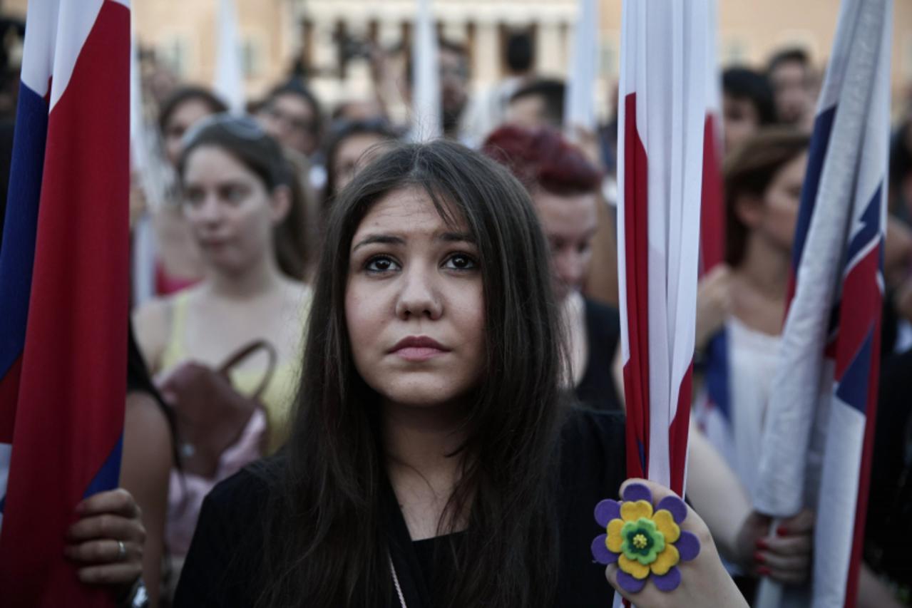 'Supporters of the Communist-affiliated trade union PAME take part in an anti-austerity rally in front of the parliament in Athens July 11, 2013.  From police to garbage collectors, Greek municipal wo