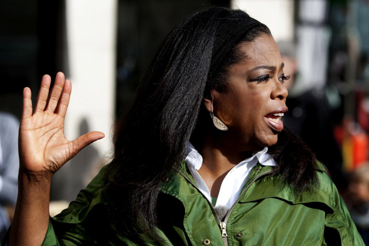 'US TV personality Oprah Winfrey waves to onlookers as she walks along the main street of Copenhagen on September 30, 2009. Winfrey arrived in support of the Chigaco delegation in the vote for the Sum