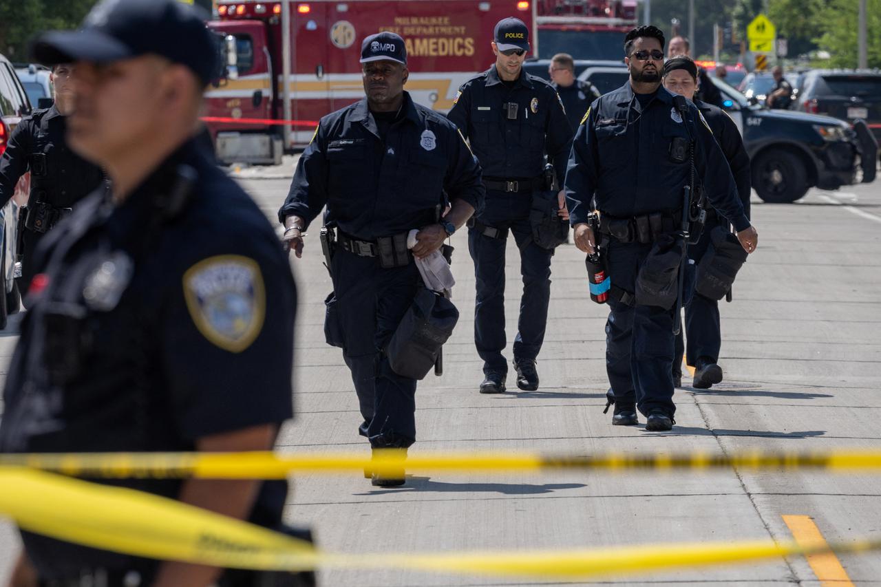 Officers walk near police shooting in Milwaukee