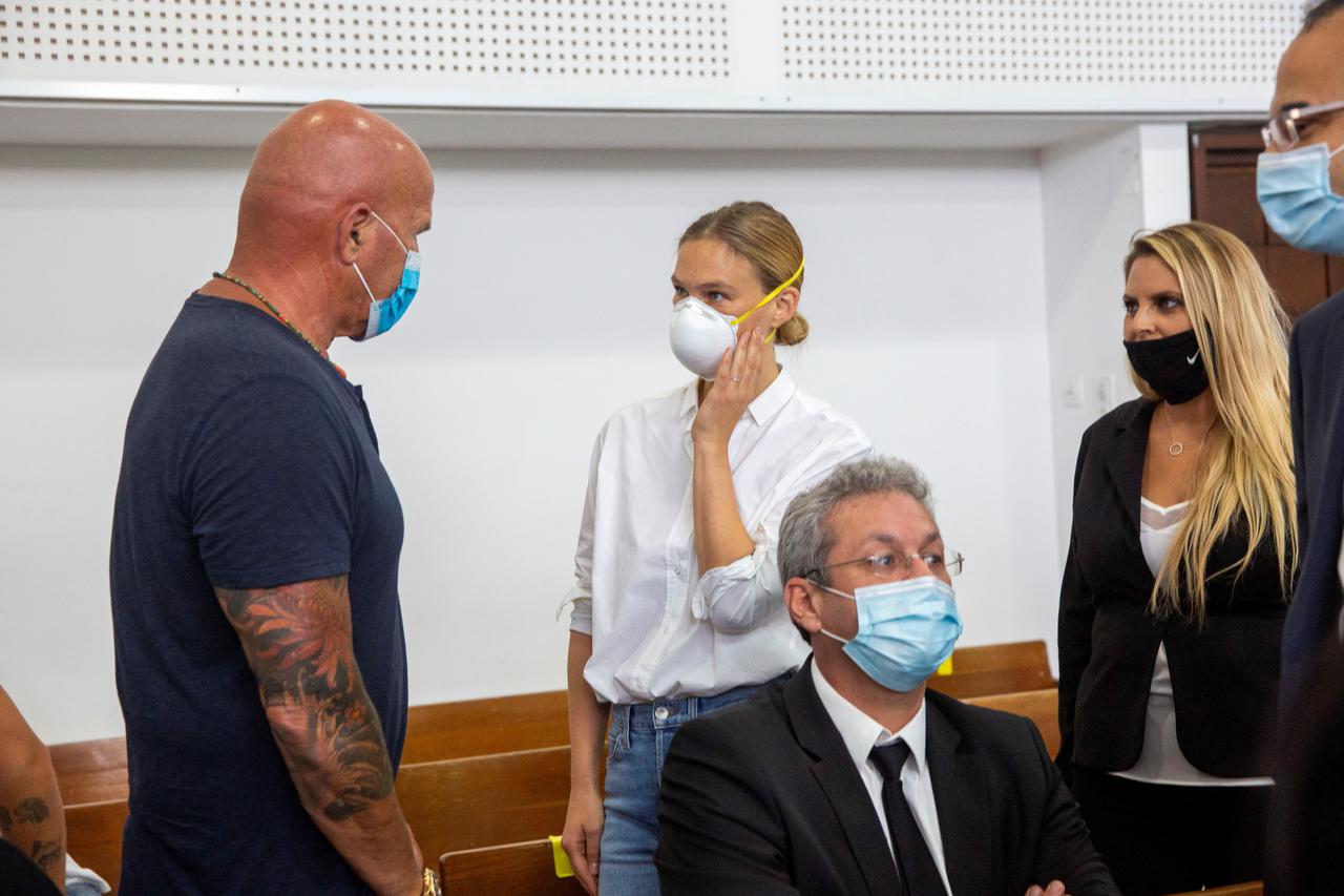 Israeli model Bar Refaeli wears a face mask as she arrives for a hearing in the tax evasion case against her and her mother Tzipi, at a court in Tel Aviv, Israel