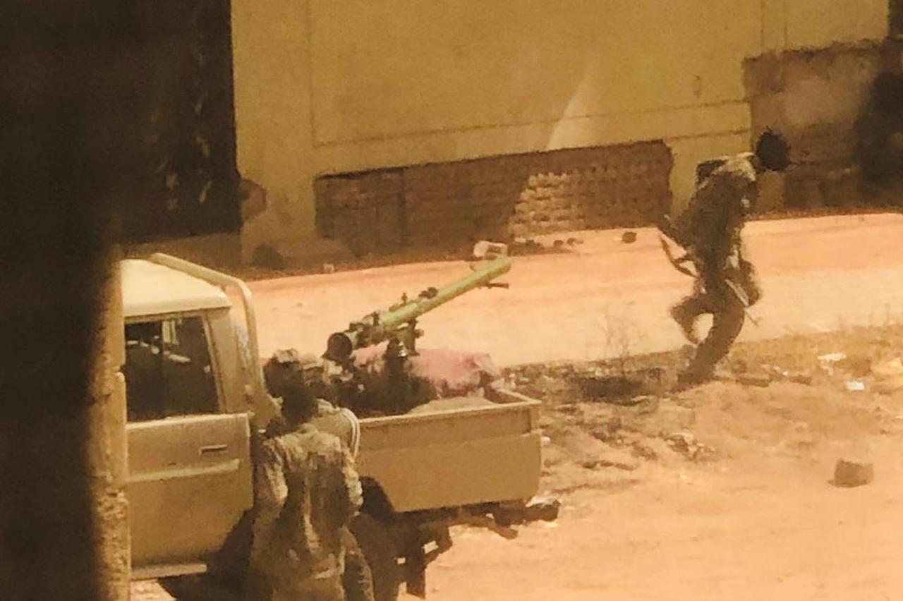 A military vehicle and soldiers said to be from the Sudanese armed forces are seen on a street in Khartoum