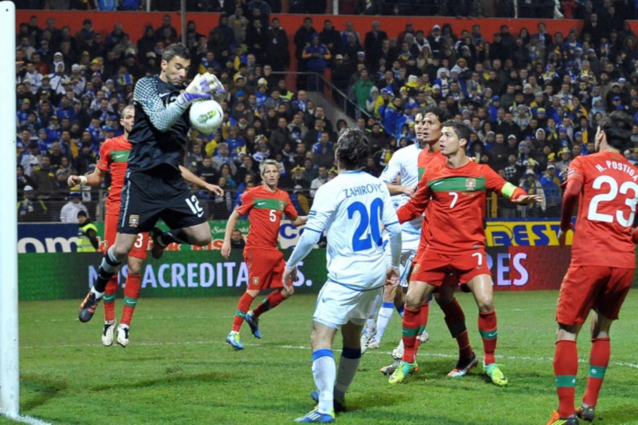 'Portugal\'s goalkeeper Rui Pedro dos Santos Patricio (L) saves a ball after a shot by Bosnia\'s Adnan Zahirovic (C) during their Euro 2012 play-off first leg football match Bosnia and Herzegovina vs 