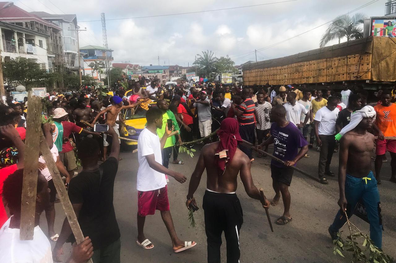 Protesters carry the body of a five-year-old girl killed by a military police officer through the streets of Buea, Cameroon