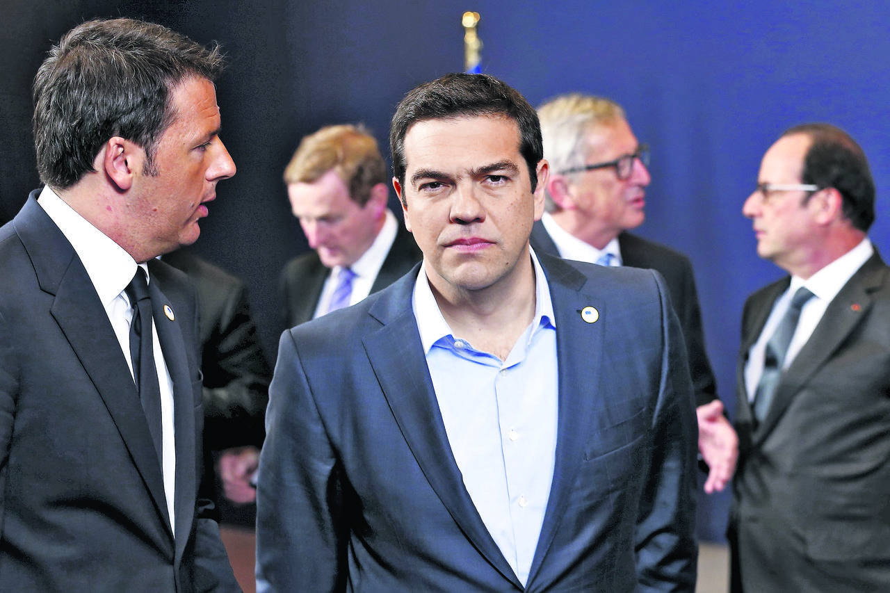 Italy's Prime Minister Matteo Renzi (front L-R) talks to his Greek counterpart Alexis Tsipras next to European Commission President Jean-Claude Juncker (back 2nd R) and France's President Francois Hollande (back R) during a European Union leaders summit i