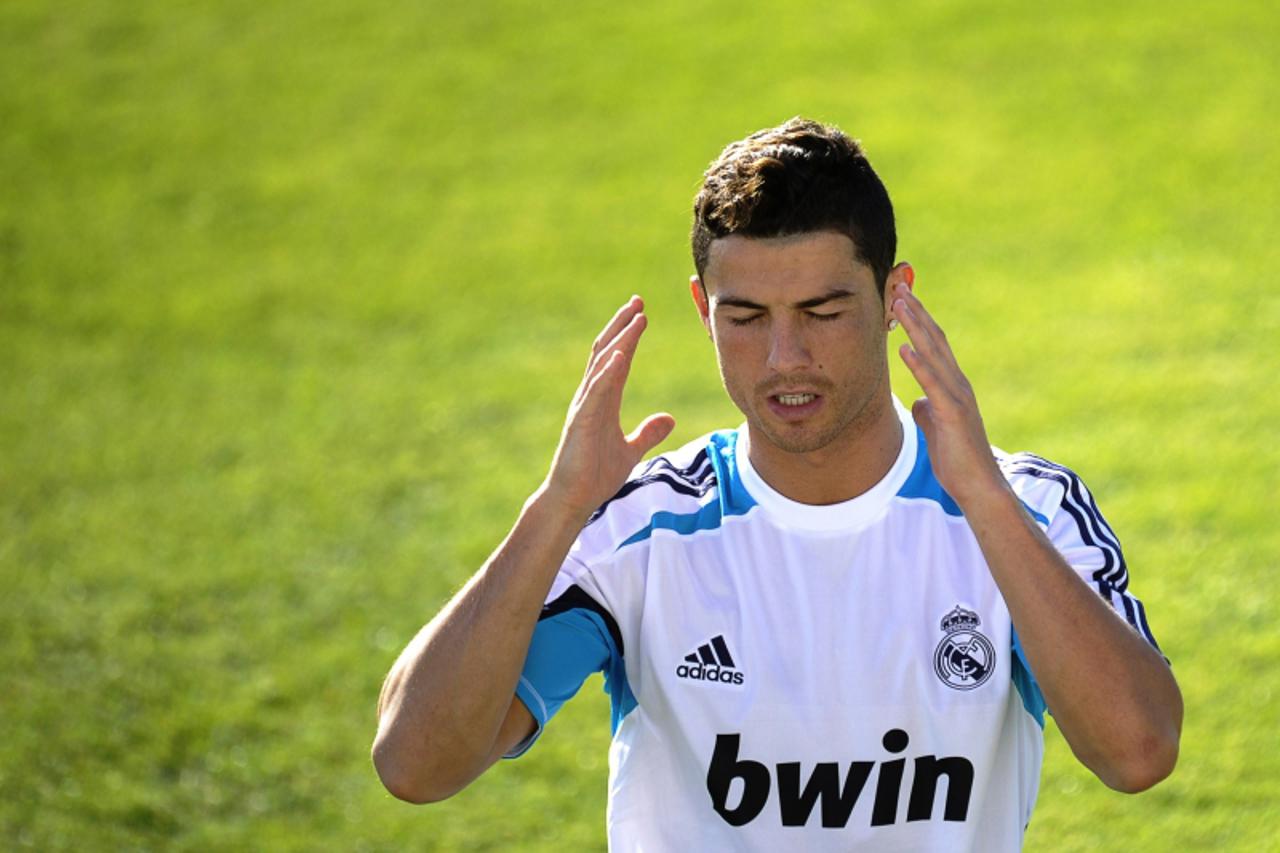 'Real Madrid\'s Portuguese forward Cristiano Ronaldo gestures during a training session in Madrid on August 25, 2012. Coach Jose Mourinho admitted that Barca were the stronger side on the night and wi
