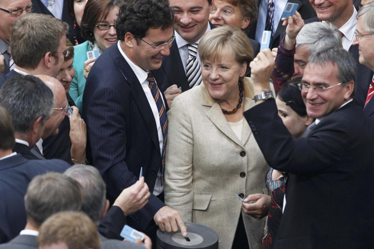 'German Chancellor Angela Merkel prepares to vote at the session of the Bundestag lower house of parliament in Berlin, September 29, 2011. Merkel faces a battle for her political survival on Thursday 
