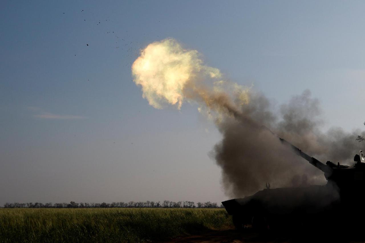 Ukrainian servicemen fire a self-propelled howitzer toward Russian positions on a frontline in Mykolaiv region