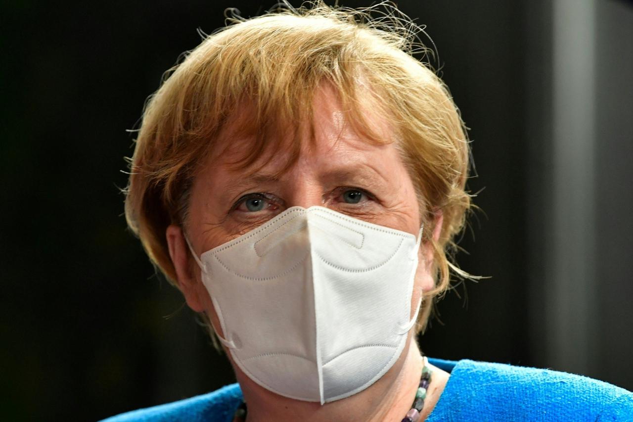 German Chancellor Angela Merkel leaves after a meeting of an EU summit on a coronavirus recovery package at the European Council building in Brussels