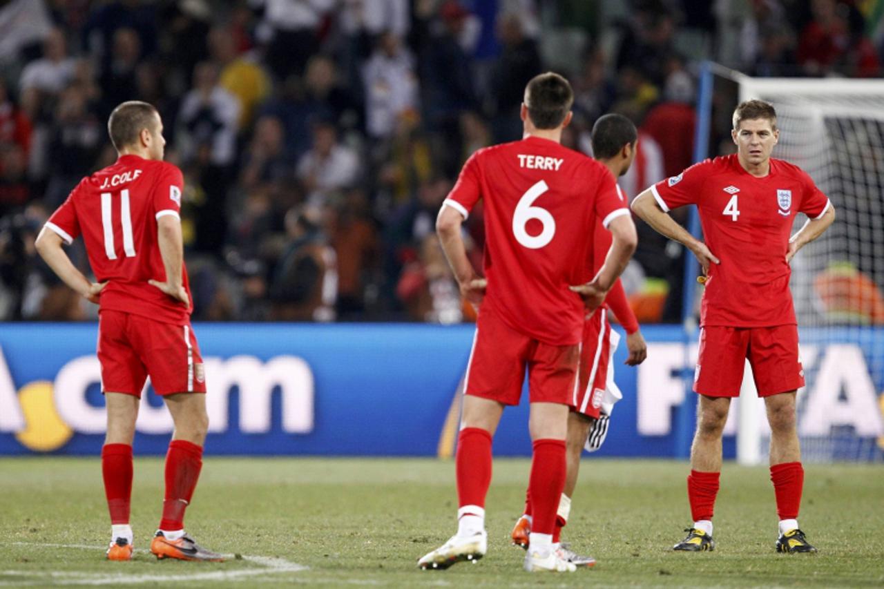 '(L-R) England\'s Joe Cole, John Terry and Steven Gerrard react at the end of a 2010 World Cup second round soccer match against Germany at Free State stadium in Bloemfontein June 27, 2010. REUTERS/Da