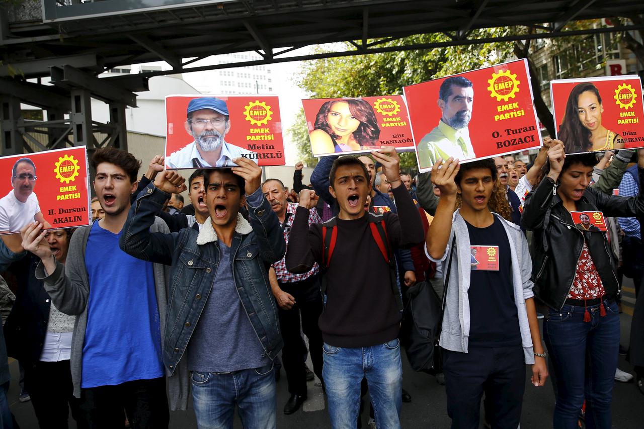 Members of the left-wing Labour Party (EMEP) carry pictures of the victims of Saturday's bomb blasts during a commemoration in Ankara, Turkey, October 11, 2015. Turkish investigators worked on Sunday to identify the perpetrators and victims of Saturday's 