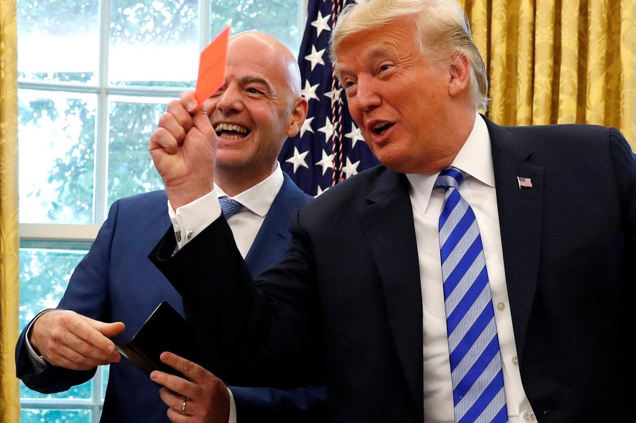 FILE PHOTO: U.S. President Donald Trump holds red card as he meets with FIFA President Infantino in the Oval Office of the White House in Washington