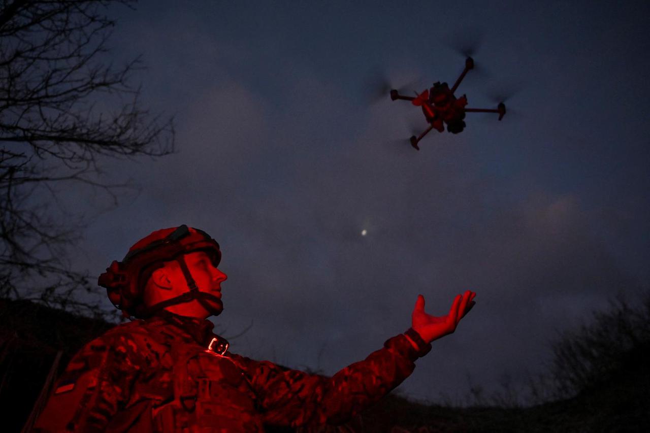 FILE PHOTO: Policeman of the 'Khyzhak' Brigade launches a drone at a position in a front line near the town of Toretsk