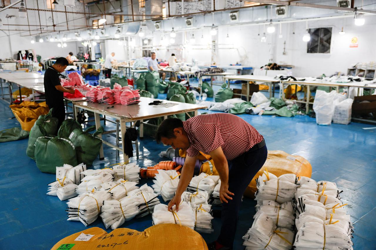 Employees packs finished products for SHEIN at a garment factory in Guangzhou