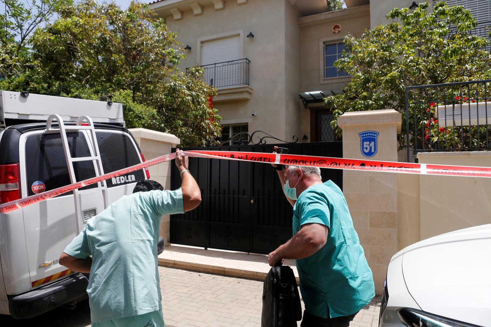 Doctor Chen Kugel, head of Israel National Center of Forensic Medicine and his colleague, pass through a police cordon as they enter China's ambassador to Israel, Du Wei's house in Herzliya, near Tel Aviv, Israel Doctor Chen Kugel, head of Israel National Center of Forensic Medicine and his colleague, pass through a police cordon as they enter China's ambassador to Israel, Du Wei's house in Herzliya, near Tel Aviv, Israel May 17, 2020. REUTERS/Nir Elias NIR ELIAS