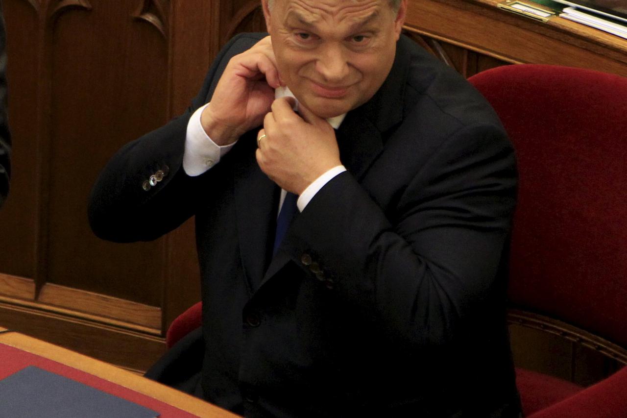 Hungarian Prime Minister Viktor Orban reacts before he addresses Parliament in Budapest, Hungary, November 16, 2015. REUTERS/Bernadett Szabo