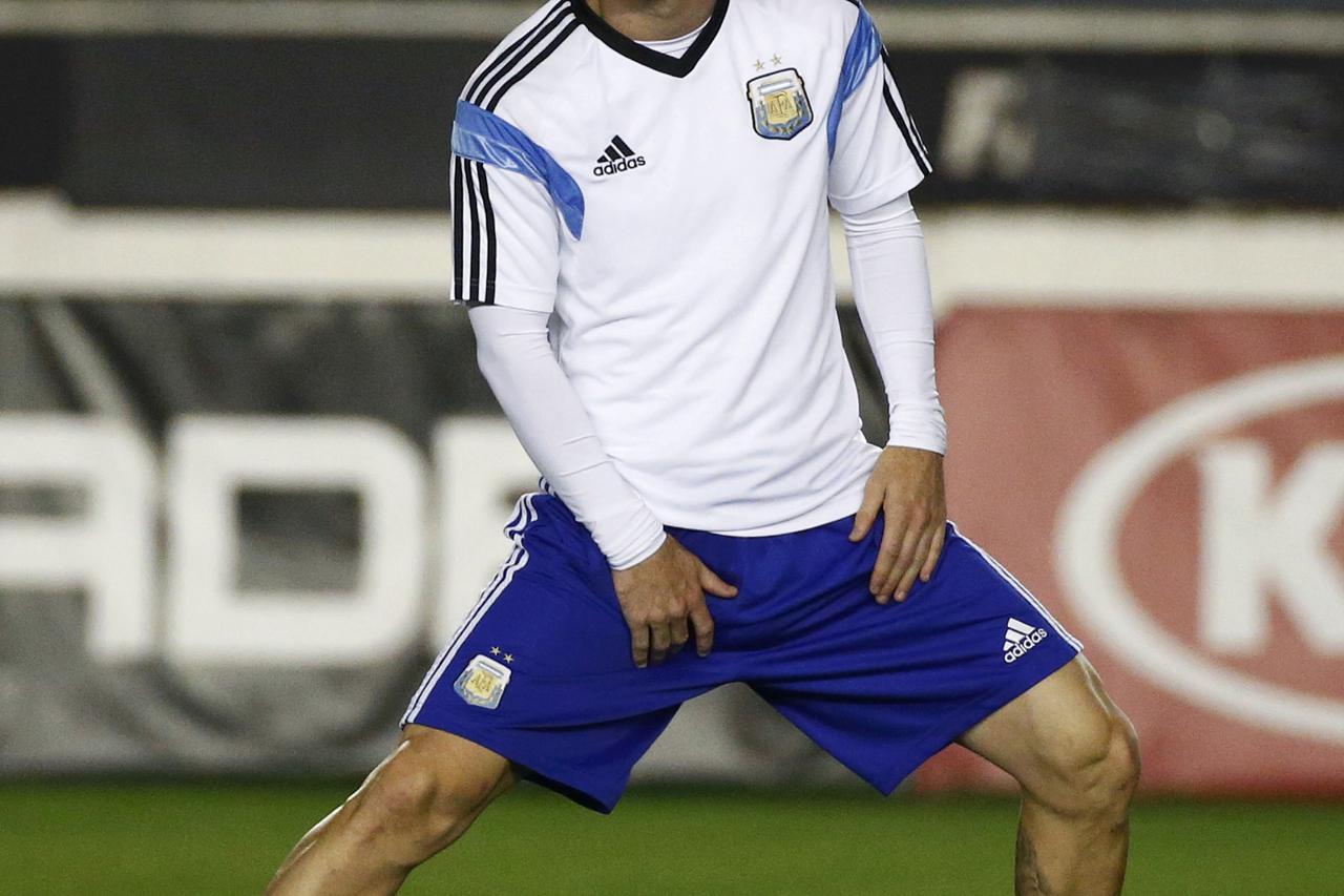 Argentina's national soccer team player Lionel Messi stretches during a training session in Rio de Janeiro July 12, 2014, ahead of their 2014 World Cup Final soccer match against Germany on July 13.    REUTERS/Michael Dalder (BRAZIL  - Tags: SPORT SOCCER 