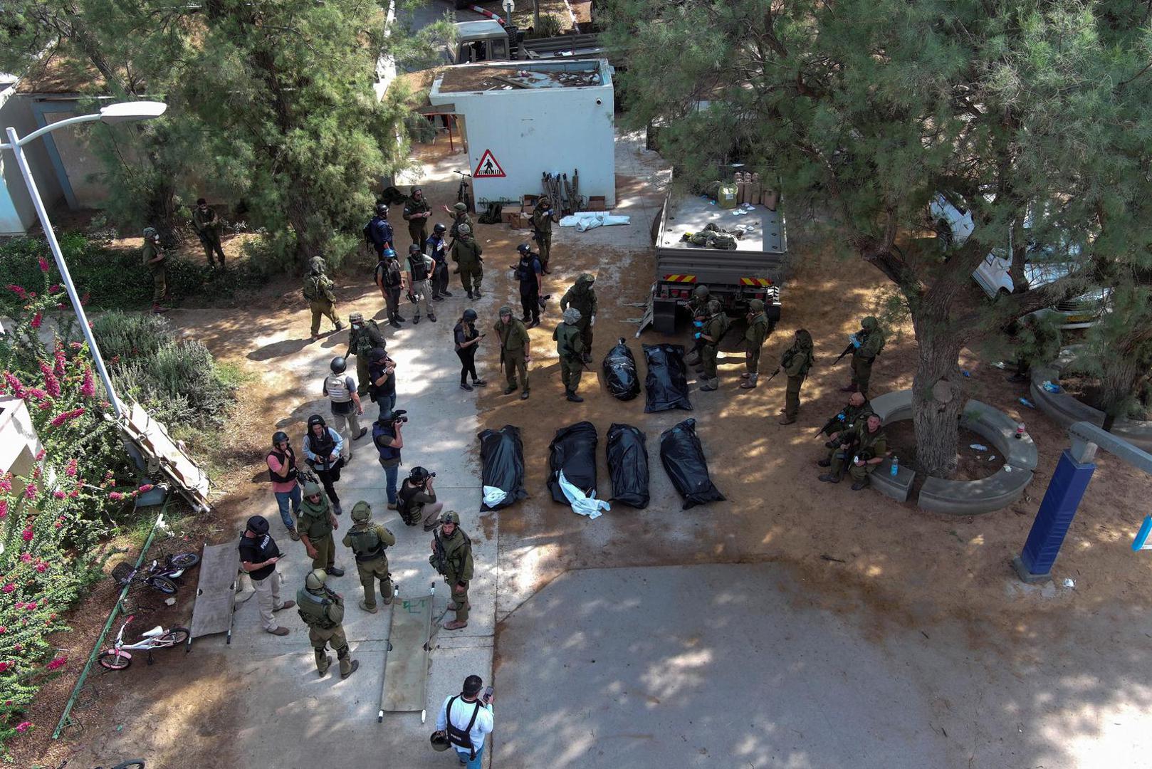 An aerial view shows the bodies of victims of an attack following a mass infiltration by Hamas gunmen from the Gaza Strip, lie on the ground in Kibbutz Kfar Aza, in southern Israel, October 10, 2023. REUTERS/Ilan Rosenberg Photo: ILAN ROSENBERG/REUTERS