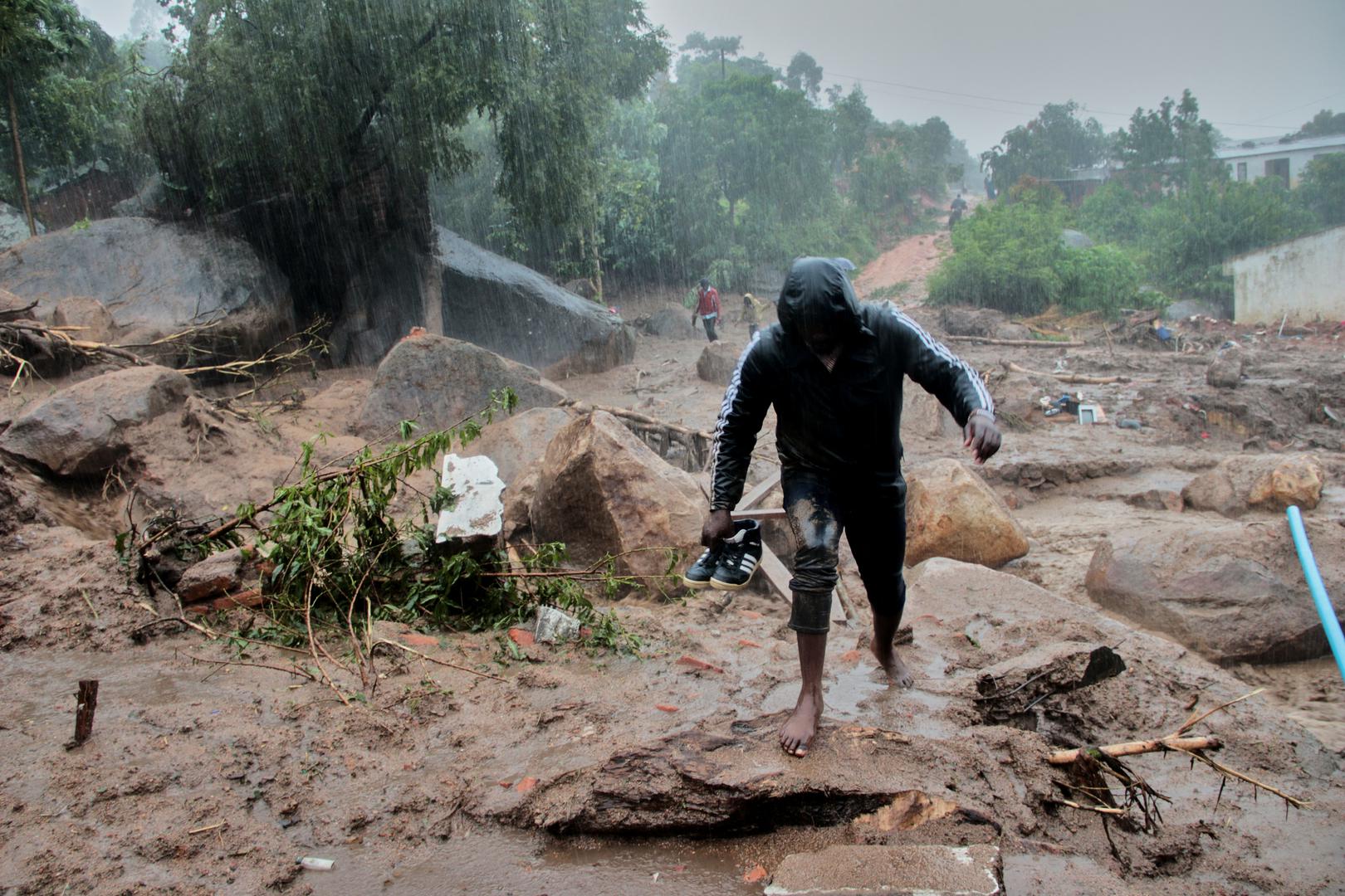 A man walks away from buildings damaged by Cyclone Freddy in Chilobwe, Blantyre, Malawi, March 13, 2023. REUTERS/Eldson Chagara. Photo: Eldson Chagara/REUTERS
