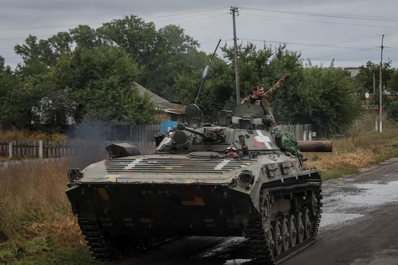 Ukrainian service members ride a BMP-2 infantry fighting vehicle in Kharkiv region