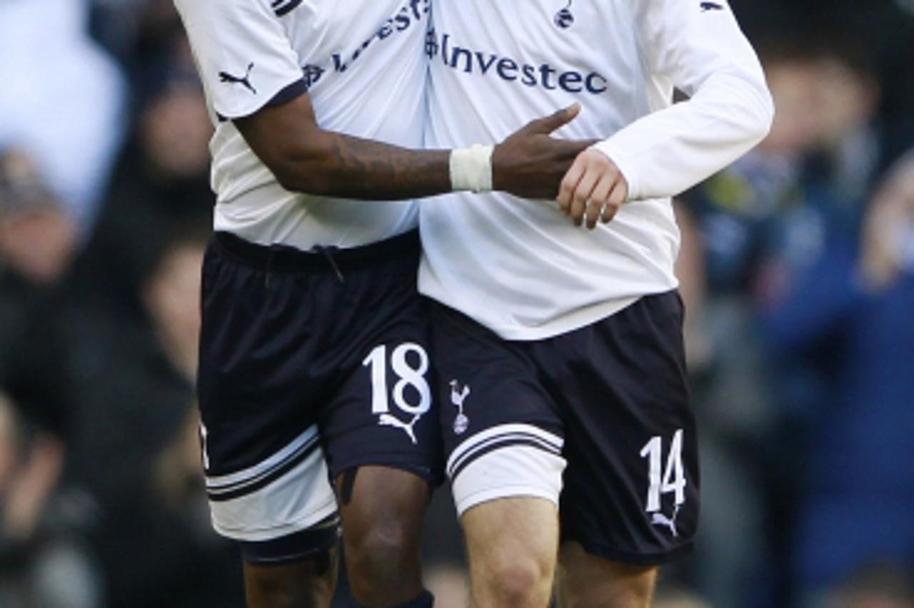 \'Tottenham Hotspur\'s Jermain Defoe (L) celebrates his second goal against Charlton Athletic with Luka Modric (R) during their FA Cup soccer match at White Hart Lane in London January 9, 2011.    REU