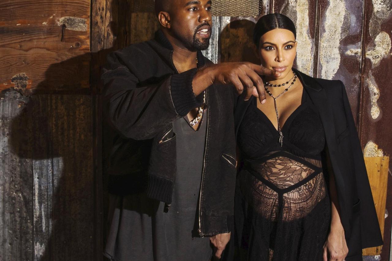Musician Kanye West stands with his wife Kim Kardashian after watching the Givenchy Spring/Summer 2016 collection during New York Fashion Week in New York September 11, 2015.  REUTERS/Lucas Jackson