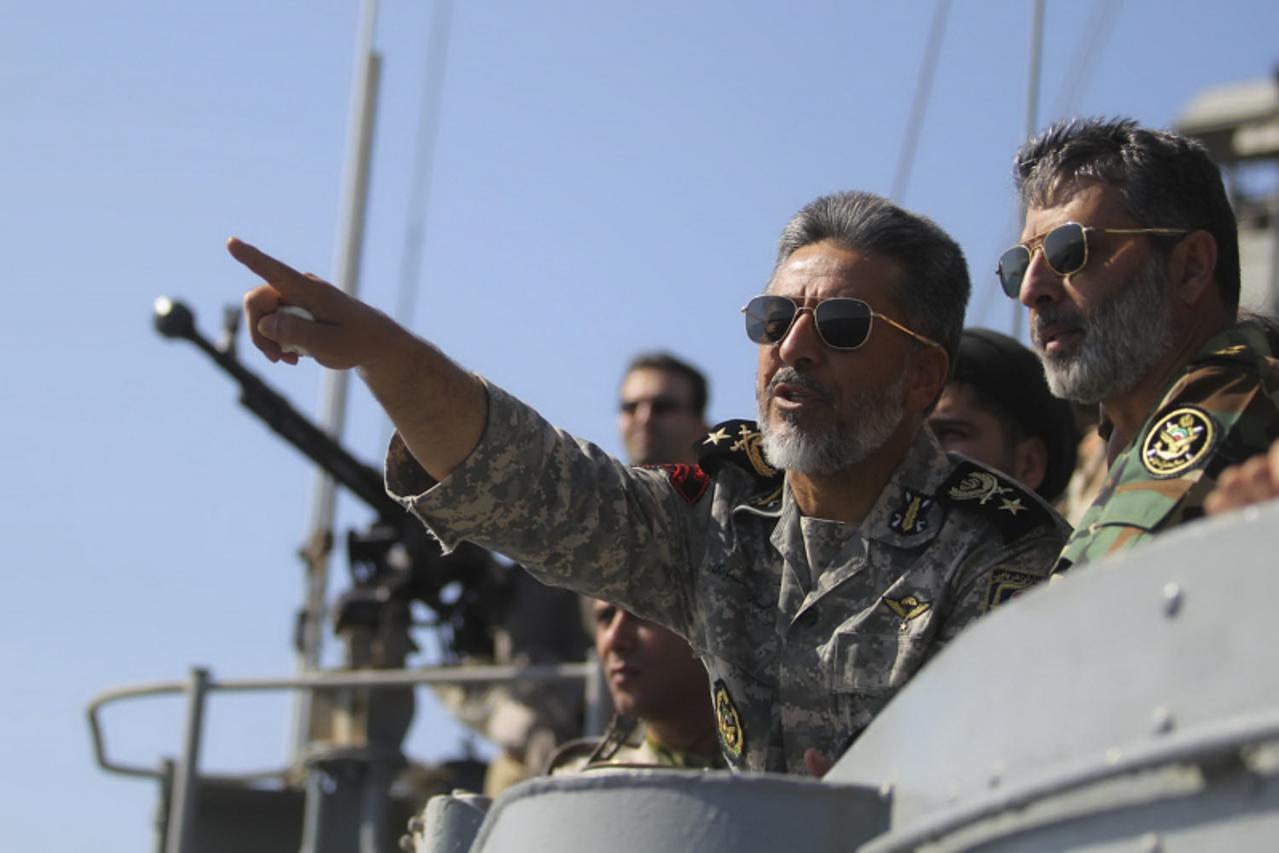 \'Iran\'s Navy commander Habibollah Sayyari (C) points while standing on a naval ship during Velayat-90 war game on Sea of Oman near the Strait of Hormuz in southern Iran January 1, 2012. Iran test-fi