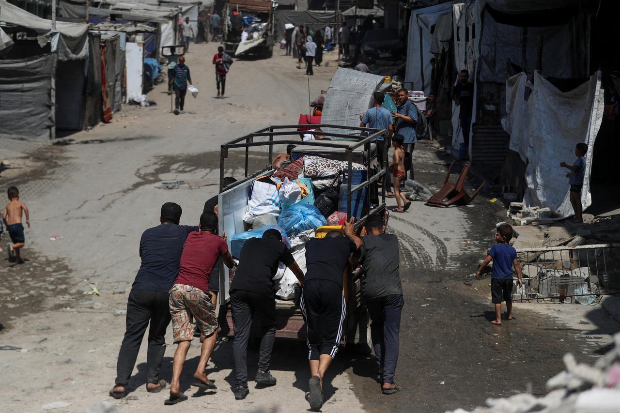 Displaced Palestinians make their way as they flee amid an Israeli military operation, in Gaza City