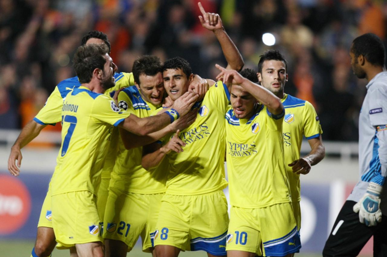 \'Apoel\'s Ailton is congratulated after scoring a goal against Portugal\'s Porto during their Champion League football match, Group G, played at the GSP Stadium in Nicosia, on November 1, 2011. AFP P