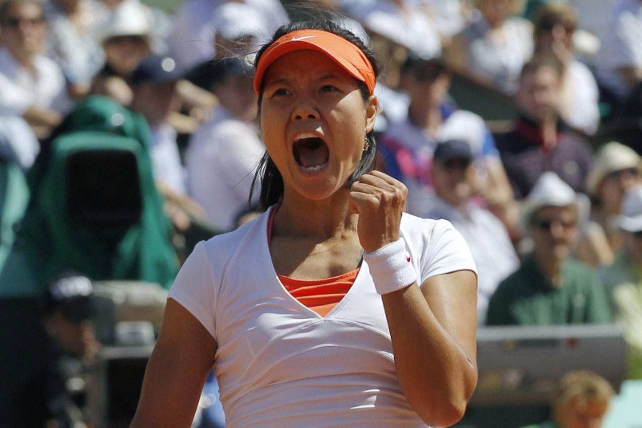 'China\'s Li Na celebrates after winning over Russia\'s Maria Sharapova during their Women\'s semi final match in the French Open tennis championship at the Roland Garros stadium, on June 2, 2011 in P