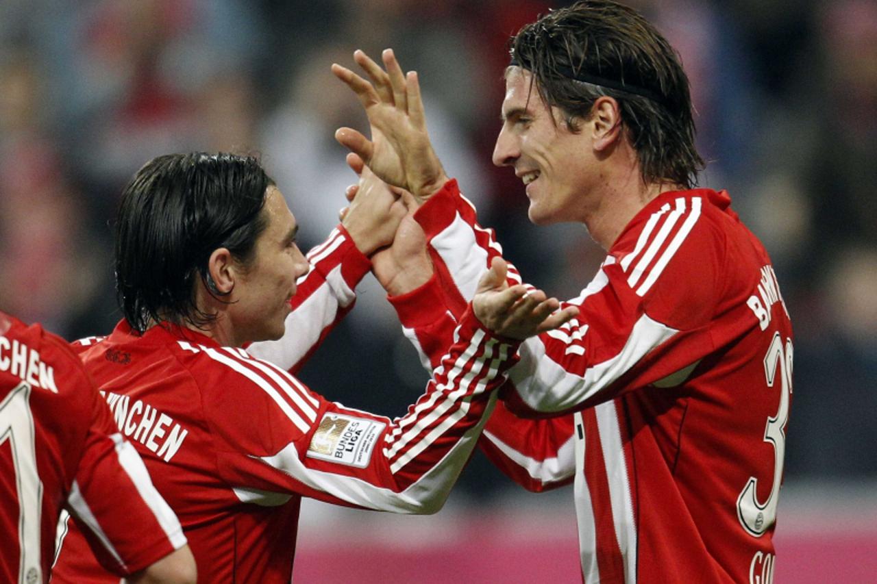 'Mario Gomez and Danijel Pranjic (L) of Bayern Munich celebrate a goal against Freiburg during their German Bundesliga first division soccer match in Munich October 29, 2010. REUTERS/Michael Dalder   